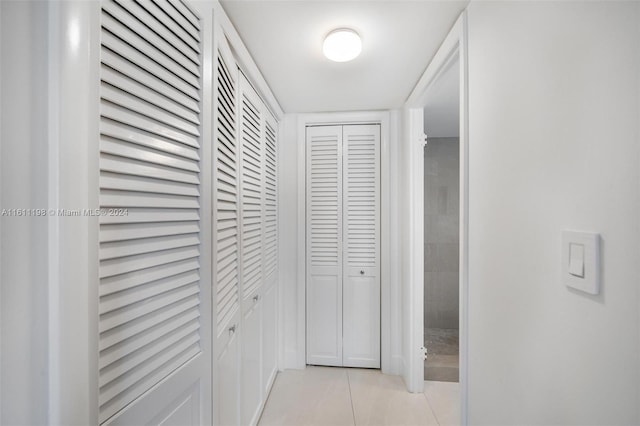 corridor with light tile patterned flooring