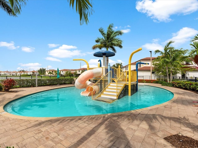 view of pool featuring a playground and a water slide