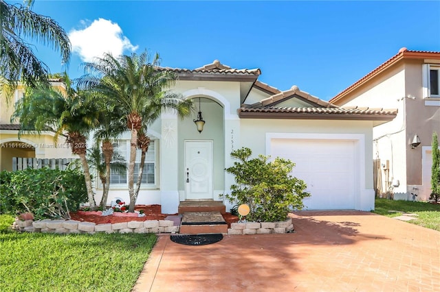 mediterranean / spanish house with a garage