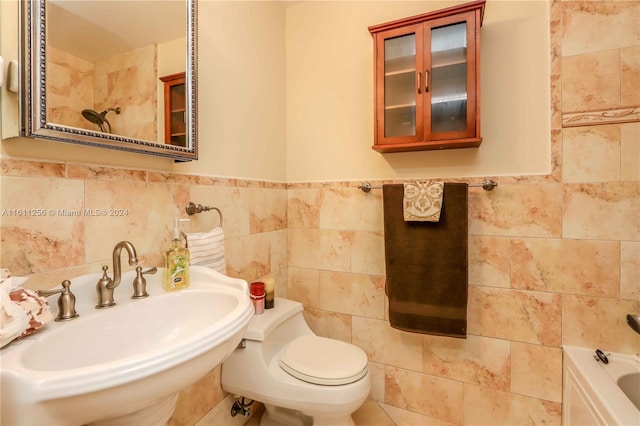 bathroom with toilet, tile walls, and sink