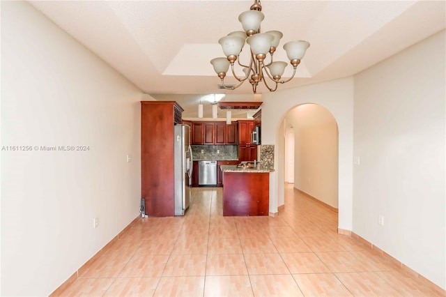 kitchen with decorative backsplash, light tile patterned floors, appliances with stainless steel finishes, and an inviting chandelier