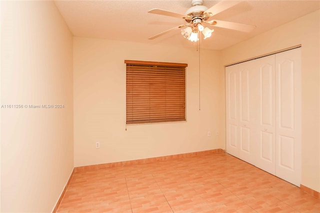 unfurnished bedroom with a closet and ceiling fan