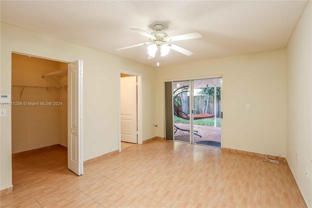 spare room featuring a textured ceiling and ceiling fan