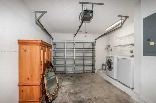 garage with washer and clothes dryer, electric panel, and a garage door opener