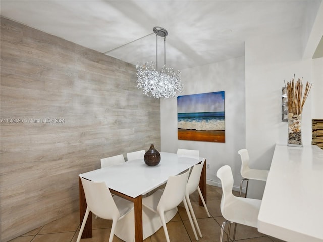 dining room with tile patterned floors and a notable chandelier