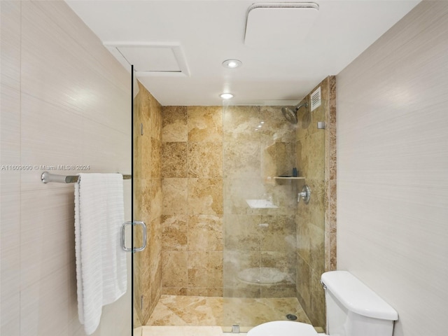 bathroom with toilet and an enclosed shower