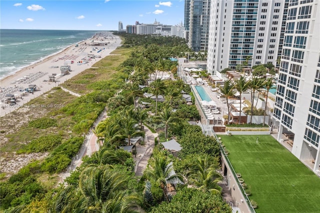 birds eye view of property with a water view and a view of the beach