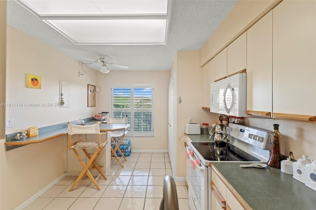 kitchen featuring white appliances, ceiling fan, a textured ceiling, and light tile patterned flooring