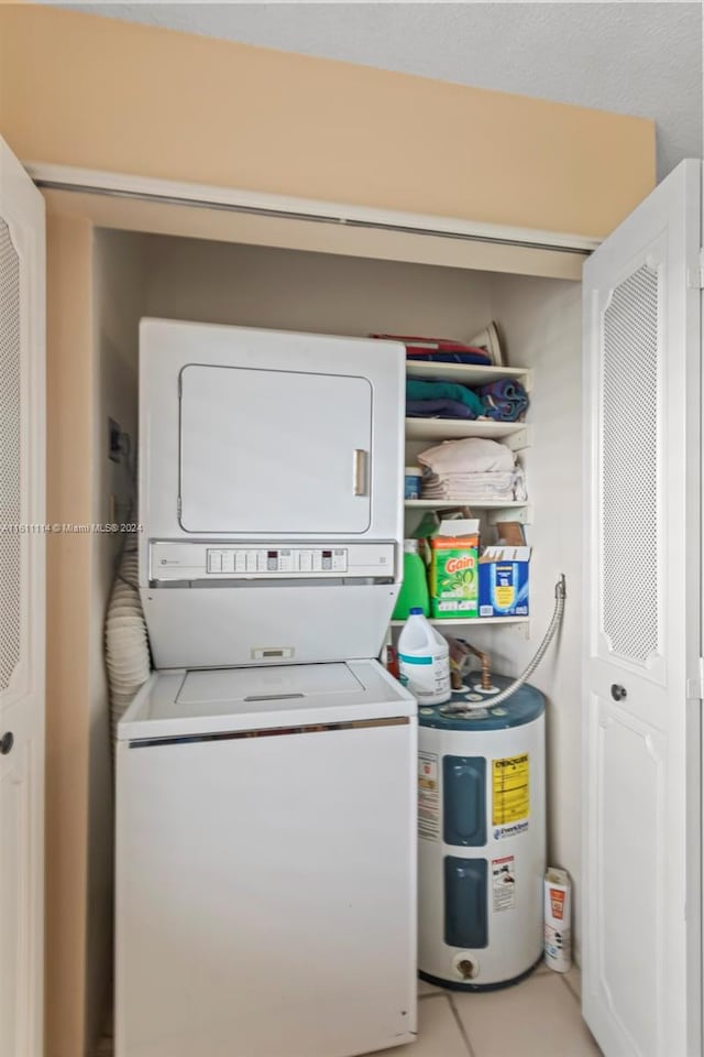 laundry area with water heater and stacked washing maching and dryer