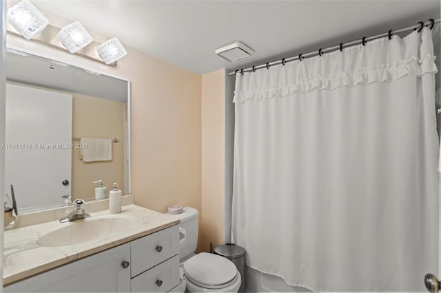 bathroom with toilet and vanity