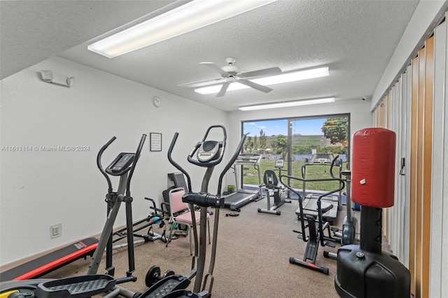 workout area with a textured ceiling and ceiling fan