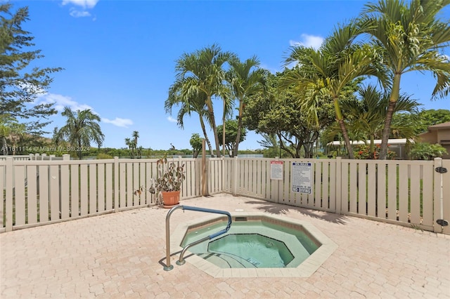 view of swimming pool with a patio and a community hot tub