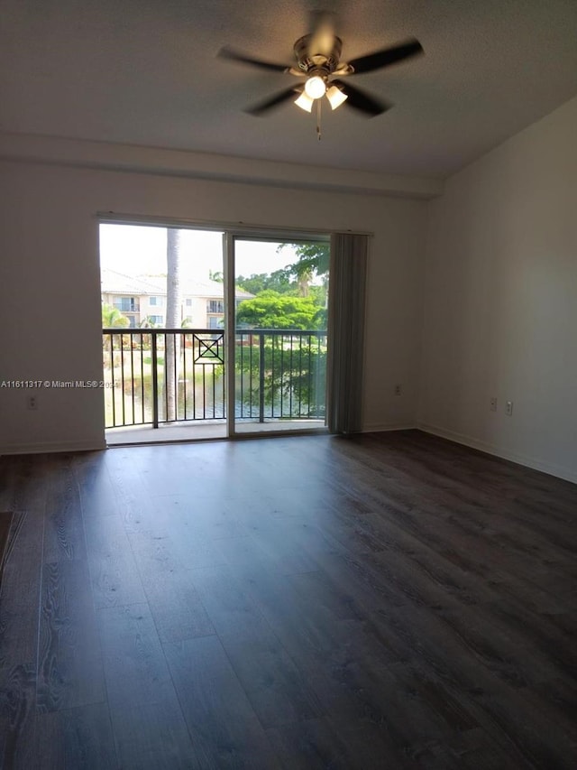 empty room with ceiling fan and hardwood / wood-style floors