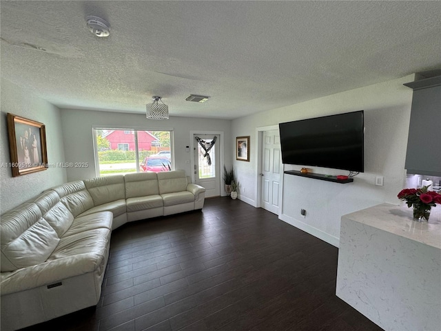 unfurnished living room featuring dark hardwood / wood-style flooring and a textured ceiling