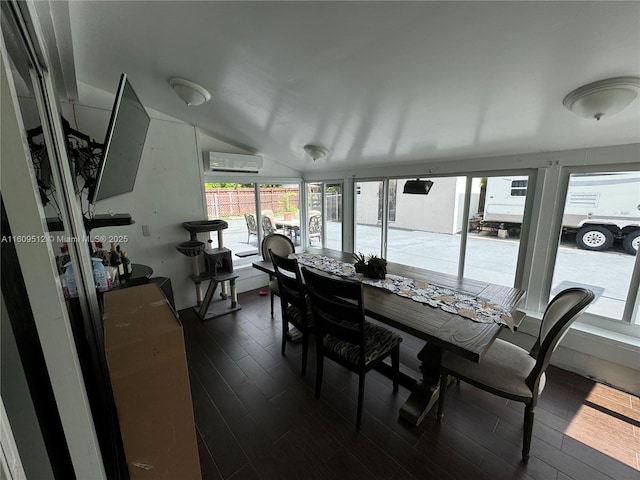 sunroom with vaulted ceiling, a wall unit AC, and wood finished floors