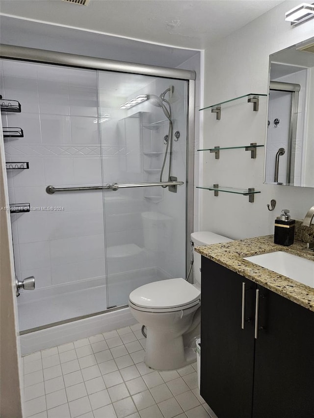 bathroom with walk in shower, tile patterned floors, vanity, and toilet