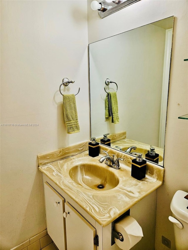 bathroom featuring tile patterned floors, vanity, and toilet