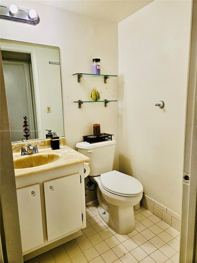 bathroom with tile patterned flooring, vanity, and toilet