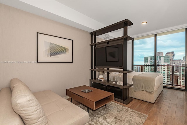 living room featuring hardwood / wood-style flooring and a wall of windows