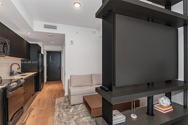 living room featuring light wood-type flooring and sink