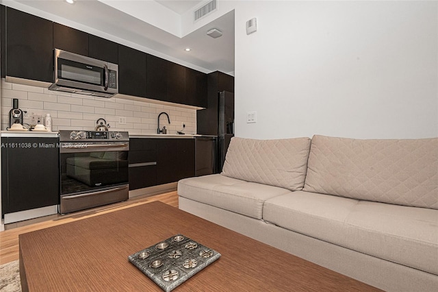 living room with light hardwood / wood-style flooring and sink