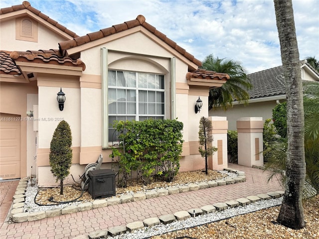 view of front of house with a tile roof and stucco siding