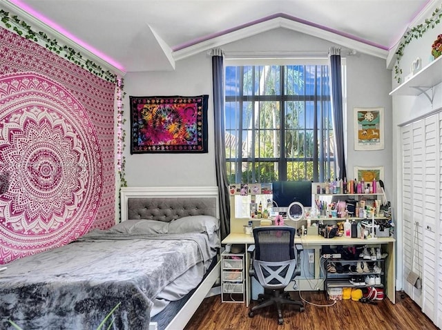 bedroom featuring lofted ceiling, crown molding, and wood finished floors