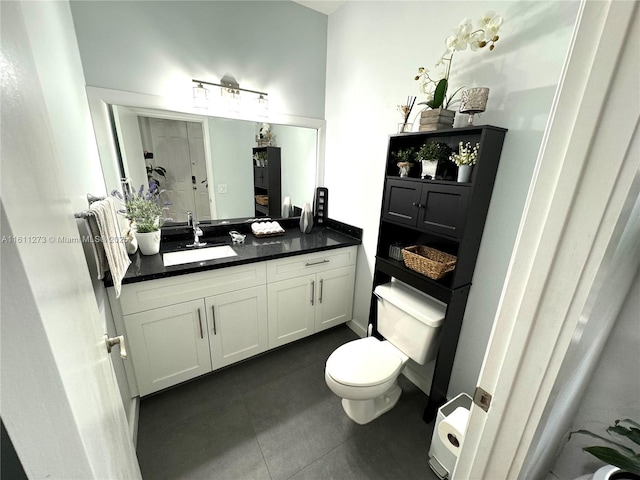 bathroom with toilet, tile patterned floors, and vanity