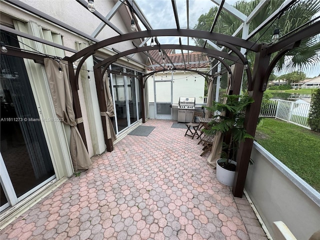 view of patio / terrace with a grill, fence, and a pergola