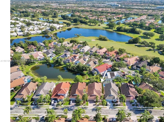 drone / aerial view featuring a water view and a residential view