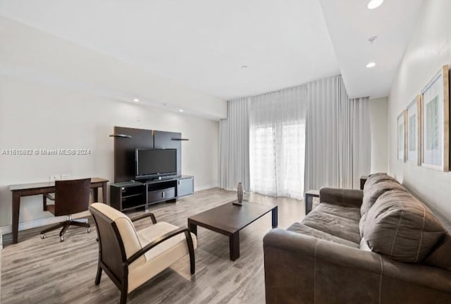 living area with wood finished floors and recessed lighting