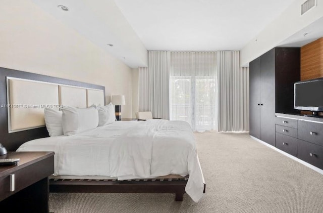 bedroom with visible vents and carpet flooring