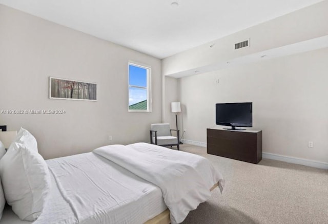 carpeted bedroom with visible vents and baseboards