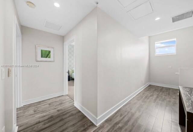 hall with wood-type flooring