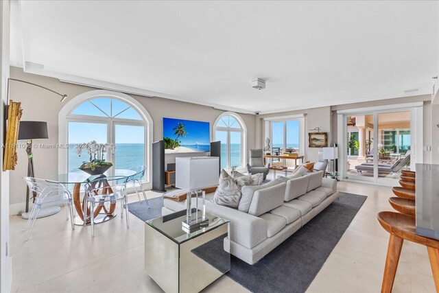 kitchen with a breakfast bar, light tile patterned floors, stainless steel built in fridge, a kitchen island, and island exhaust hood