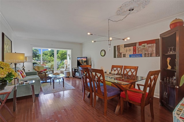 dining space featuring hardwood / wood-style floors, a chandelier, and ornamental molding