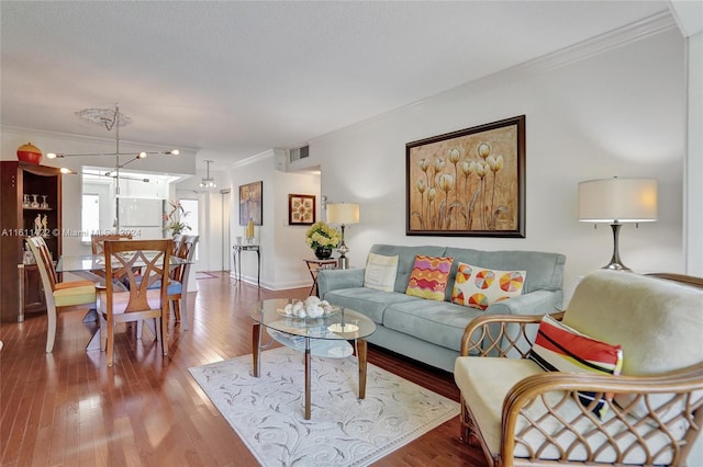 living room with hardwood / wood-style floors and ornamental molding