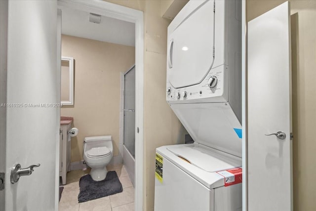 washroom with light tile patterned floors and stacked washer and clothes dryer