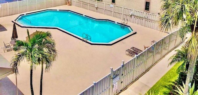 view of swimming pool featuring a patio area