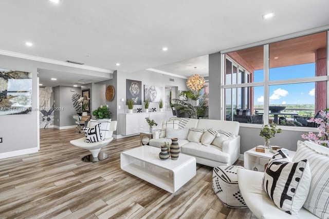 living room with light hardwood / wood-style floors, a wall of windows, and crown molding