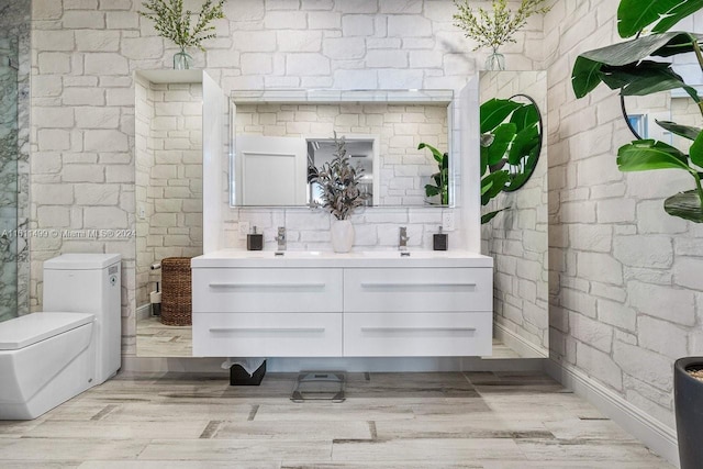 bathroom with toilet, vanity, and hardwood / wood-style flooring