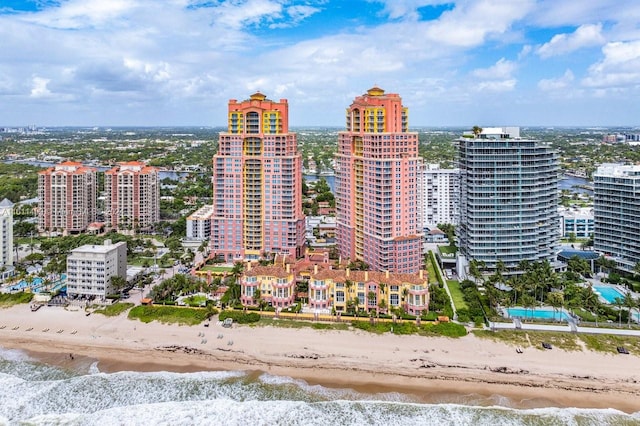 aerial view featuring a view of city, a water view, and a beach view