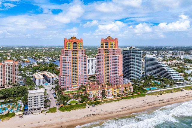 aerial view featuring a water view, a city view, and a view of the beach