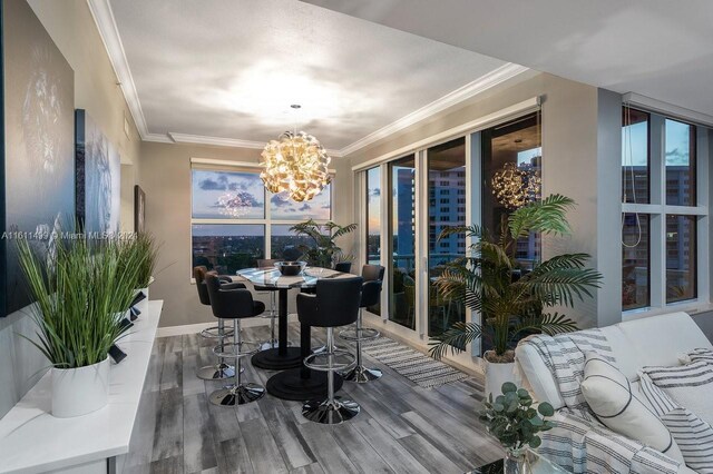 dining room with a notable chandelier, dark hardwood / wood-style floors, and crown molding