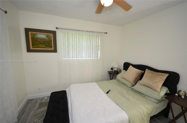 bedroom featuring ceiling fan and dark hardwood / wood-style floors