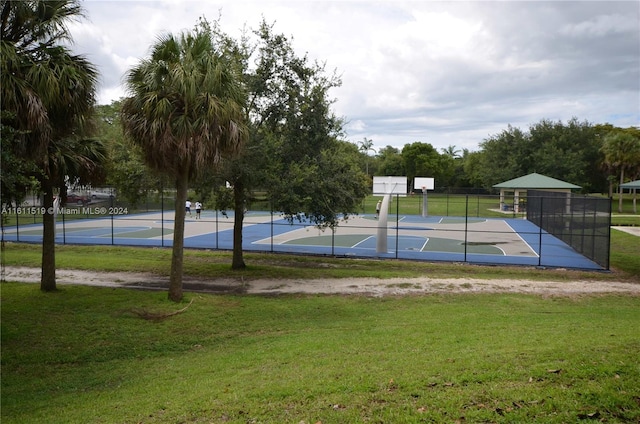 view of sport court featuring a yard