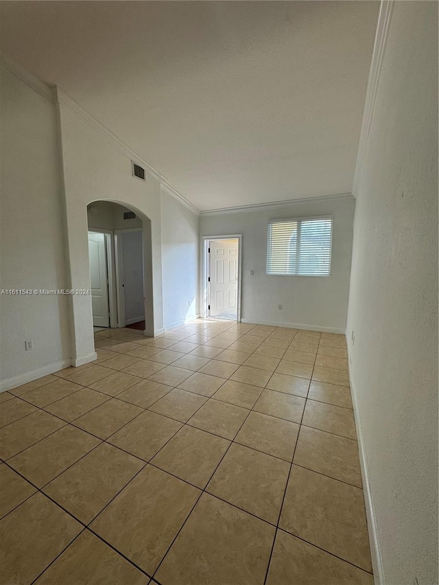 tiled empty room with crown molding