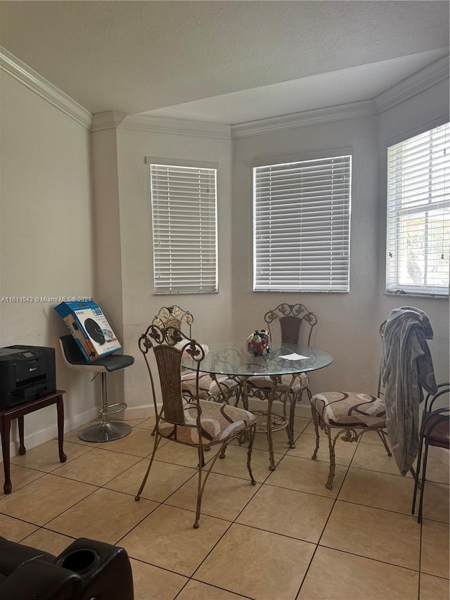 tiled dining room featuring ornamental molding