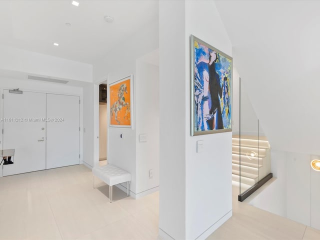 hallway featuring light tile floors