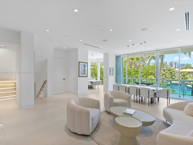 living room with a healthy amount of sunlight and a notable chandelier